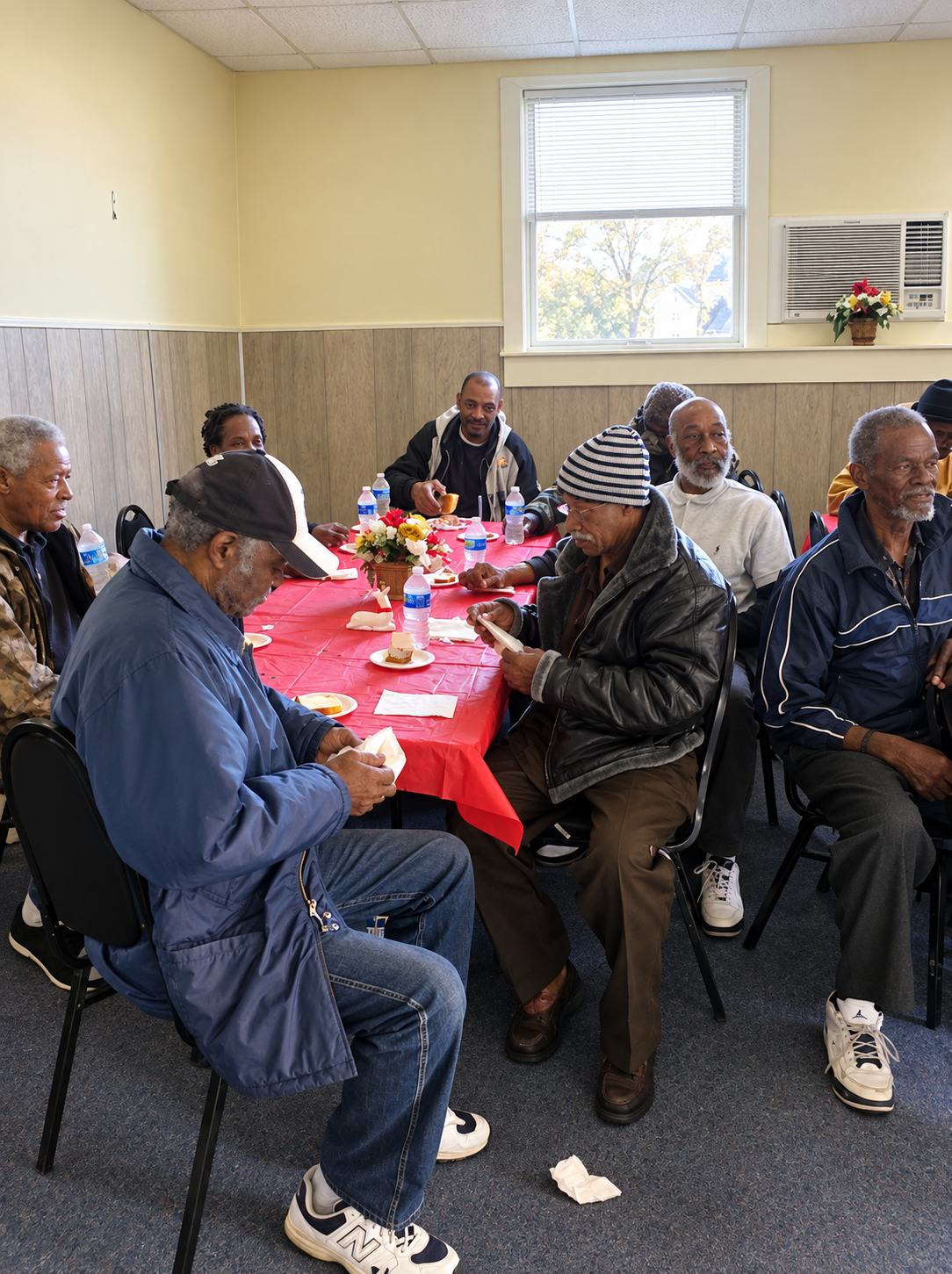 Neighbors gathered around a table for a community fellowship meal